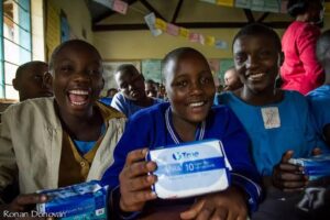 Children in Classroom Holding Sanitary Pads.