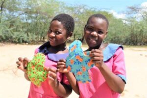 Girls in Pink Shirts with Colorful Fabric