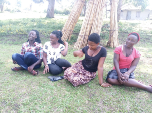 Women Sitting by Bamboo Hut