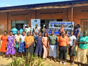 Parents of Children Sponsored by PLANE pose in a photo after receiving scholastic items