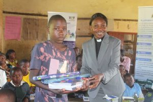 Rev.Sarah Our Board Member hands over items to Rose